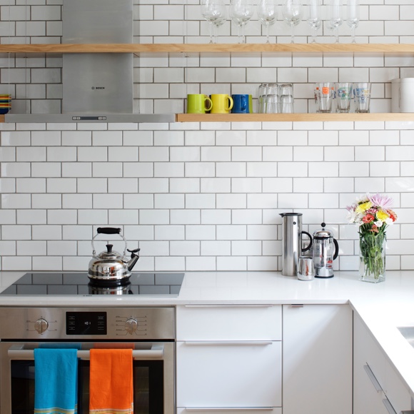 Kitchen area with subway tiles and glass stovetop